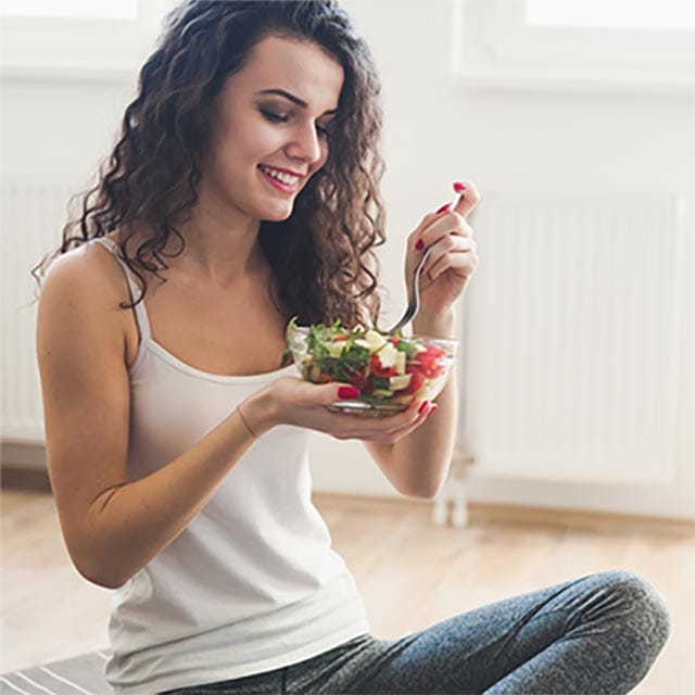 Woman eating salad